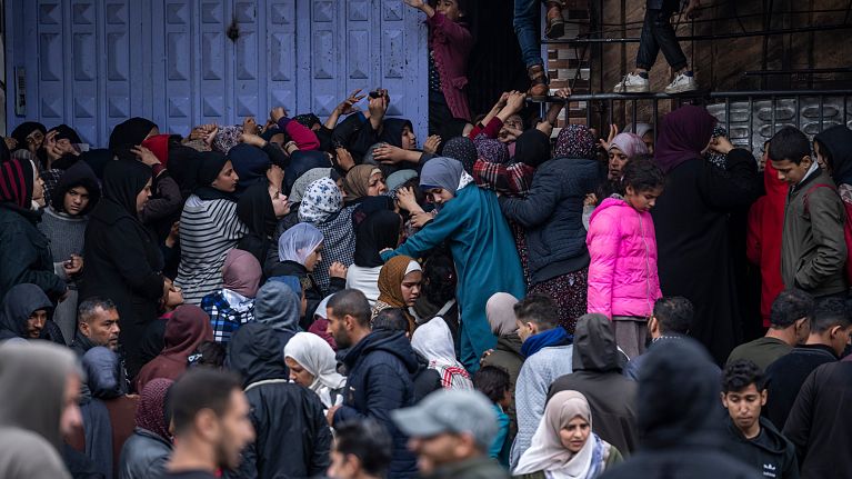 Palestinian crowds struggle to buy bread from a bakery in Rafah, Gaza Strip, Sunday, Feb. 18, 2024. Palestinian crowds struggle to buy bread from a bakery in Rafah, Gaza Strip, Sunday, Feb. 18, 2024.