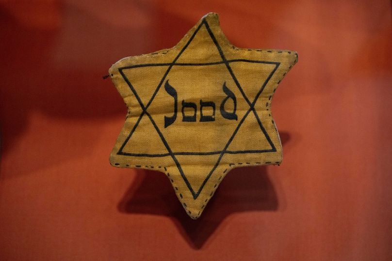 A Star of David badge with the Dutch word "Jood", or "Jew", worn during World War II, is displayed at the new National Holocaust Museum in Amsterdam