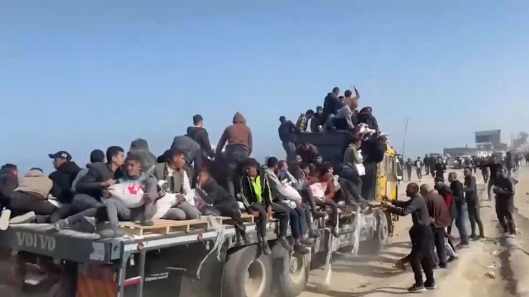 Gazans chase humanitarian aid convoys in Gaza, Wednesday, March 6, 2024. Gazans chase humanitarian aid convoys in Gaza, Wednesday, March 6, 2024.