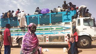 People board a truck as they leave Khartoum, Sudan, on June 19, 2023.