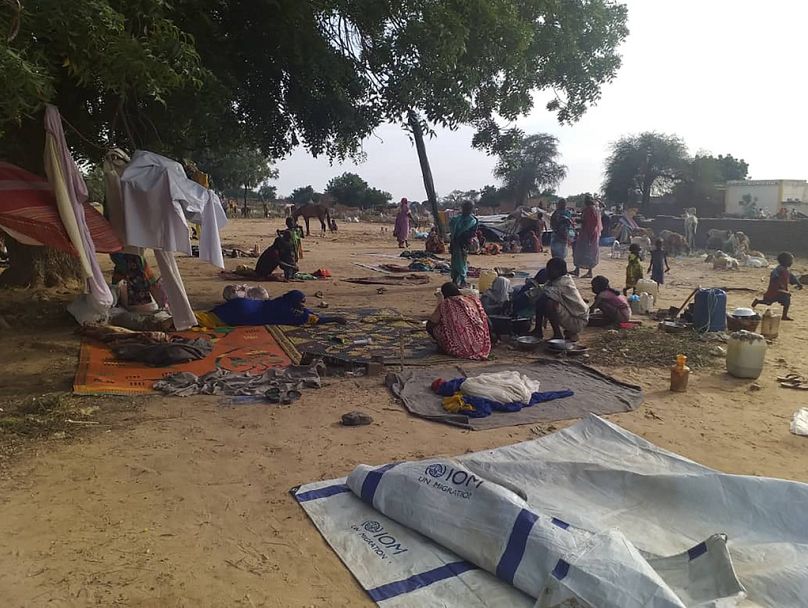 Residents displaced from a surge of violent attacks squat on blankets and in hastily made tents in the village of Masteri in west Darfur, Sudan.