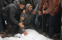 Palestinians mourn relatives killed in the Israeli bombardments of the Gaza Strip in front of the morgue of the Al Aqsa Hospital in Deir al Balah on March 7.