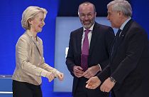 Italy's Deputy Prime Minister greets EU Commission President Ursula von der Leyen as Manfred Weber smiles, at the EPP Congress