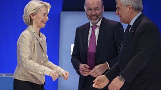 Italy's Deputy Prime Minister greets EU Commission President Ursula von der Leyen as Manfred Weber smiles, at the EPP Congress