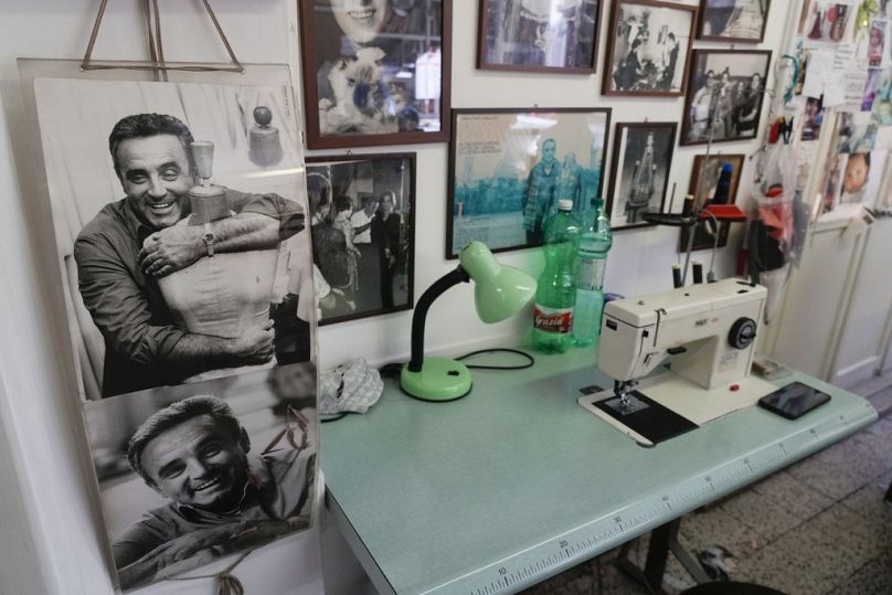 A picture of Umberto Tirelli, left, is displayed near a sewing machine at the Tirelli Atelier in Rome, Tuesday, March 5, 2024.