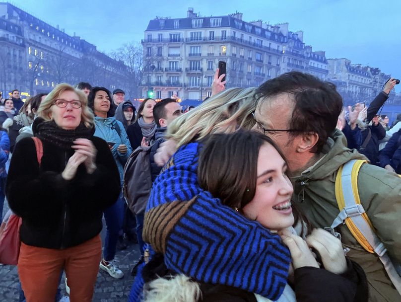 People hug each other after French lawmakers approved a bill that will enshrine a woman’s right to an abortion in the French Constitution, in Paris, March 2024