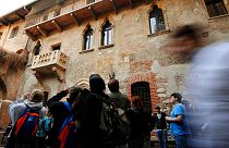 Tourists take pictures of Juliet's balcony, seen at left, in Verona, northern Italy (AP Photo/Claudio Martinelli)