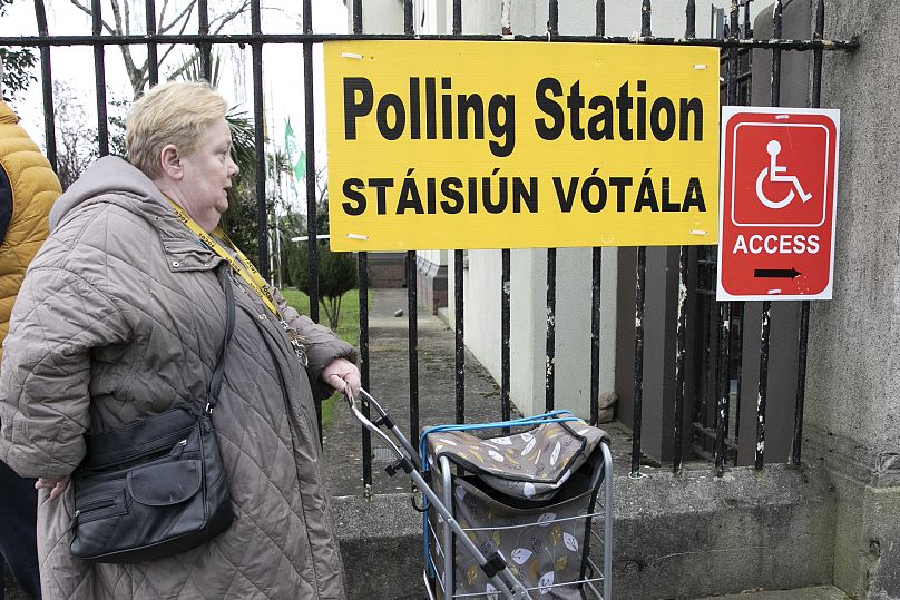 A woman arrives to vote in a referendum on the proposed changes to the wording of the Constitution relating to the areas of family and care.
