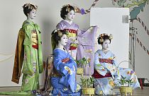 Maiko, or apprentice geiko, pose for photos ahead of the upcoming Gion Odori dance performance in Kyoto, western Japan