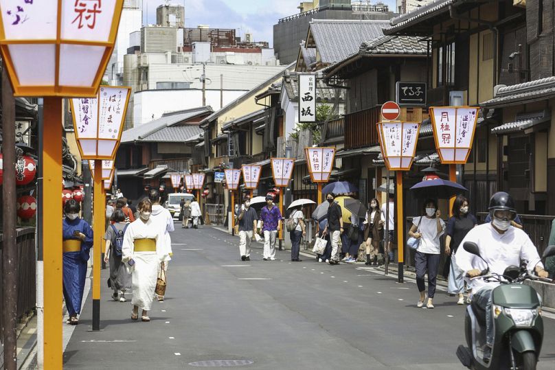 People walk along a street in Gion area, Kyoto, western Japan
