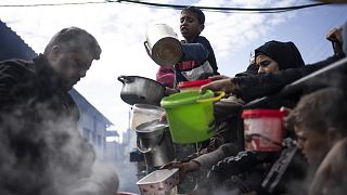 Palestinians line up for a free meal in Rafah, Gaza Strip, Friday, Feb. 16, 2024. 