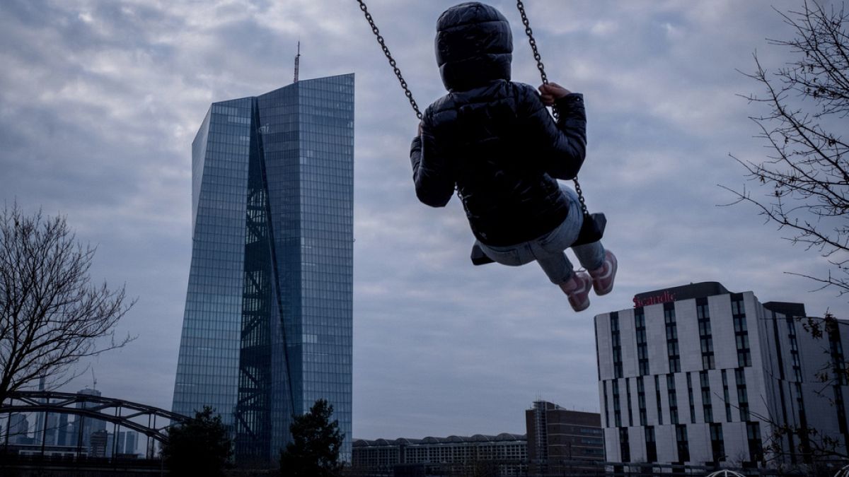 A girl swings near the European Central Bank in Frankfurt, Germany, Wednesday, March 6, 2024