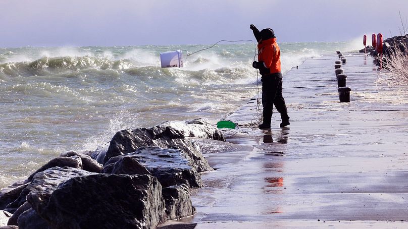 Rae-Ann Eifert, a lake monitor for the Wisconsin Department of Natural Resources, braved sub-freezing temperatures to gather buckets of water for testing off Lake Michigan.