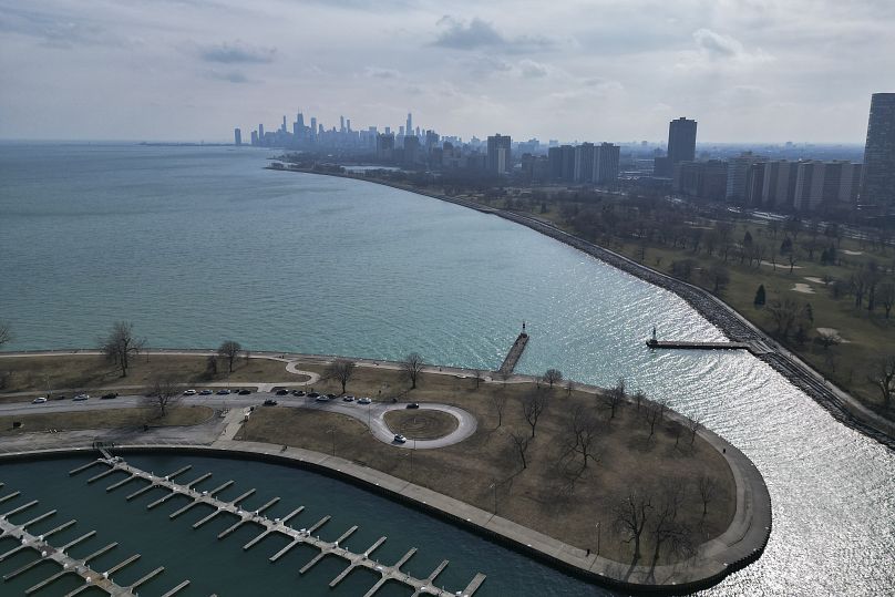 Sunlight reflects off of Lake Michigan at Montrose Harbor on an unseasonably warm day, 27 February 2024, in Chicago.