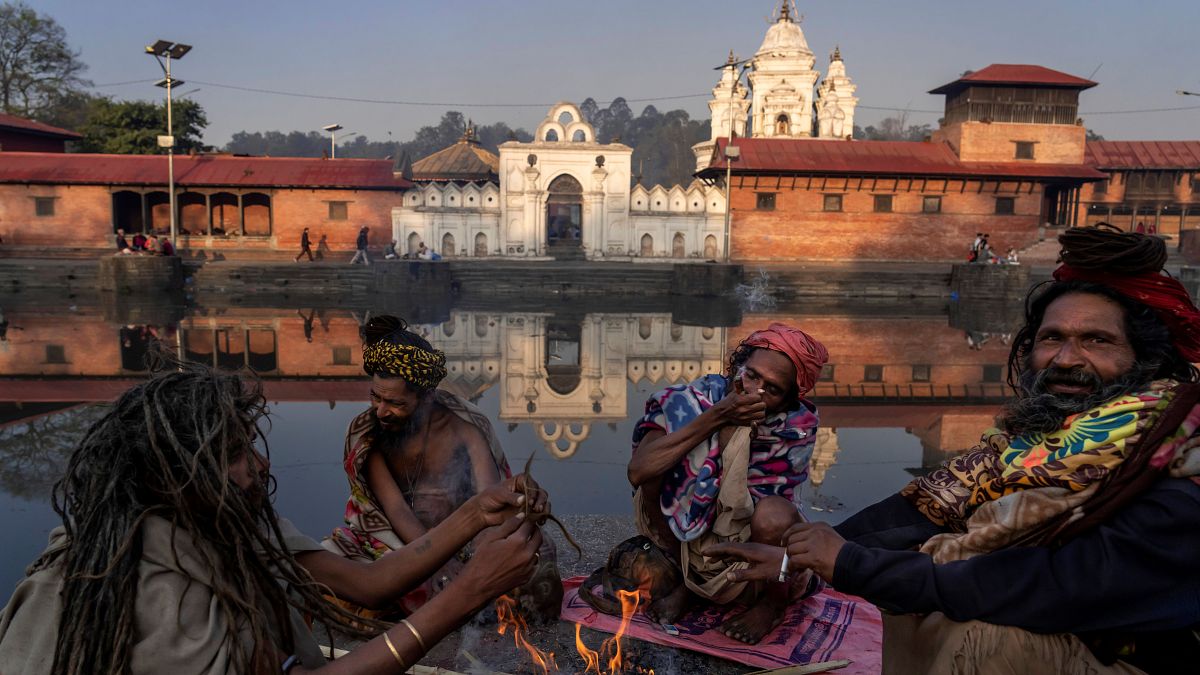 رجال الدين الهندوس من الهند يدخنون الماريجوانا على ضفة نهر باجماتي خلال مهرجان مها شيفاراتري