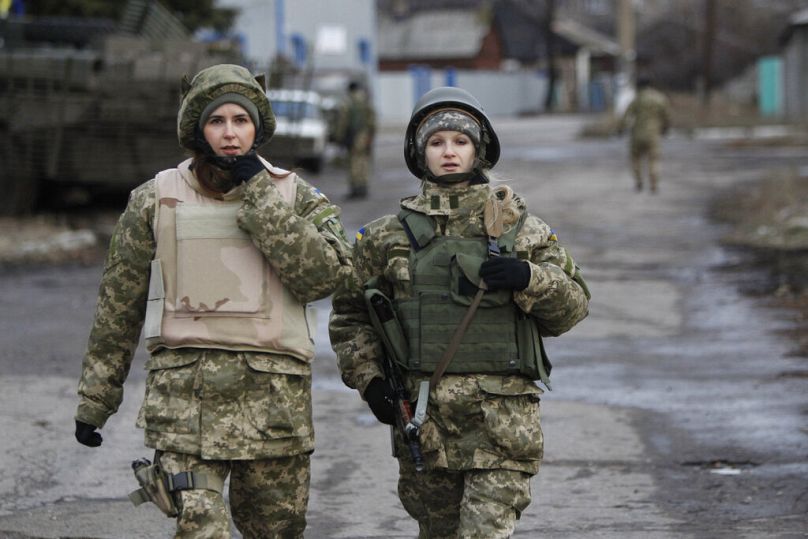 Ukrainian government army women soldiers patrol an area in the village of Debaltseve, Donetsk region, eastern Ukraine, Wednesday, Dec 24, 2014.