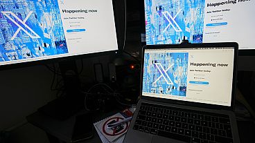 Computer monitors and a laptop display the X, formerly known as Twitter, sign-in page, July 24, 2023, in Belgrade, Serbia. 