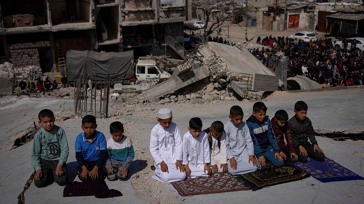 فلسطينيون يصلون أمام مسجد دمرته الغارات الجوية الإسرائيلية في رفح
