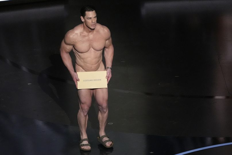 John Cena presents the award for best costume design during the Oscars on Sunday, March 10, 2024, at the Dolby Theatre in Los Angeles.
