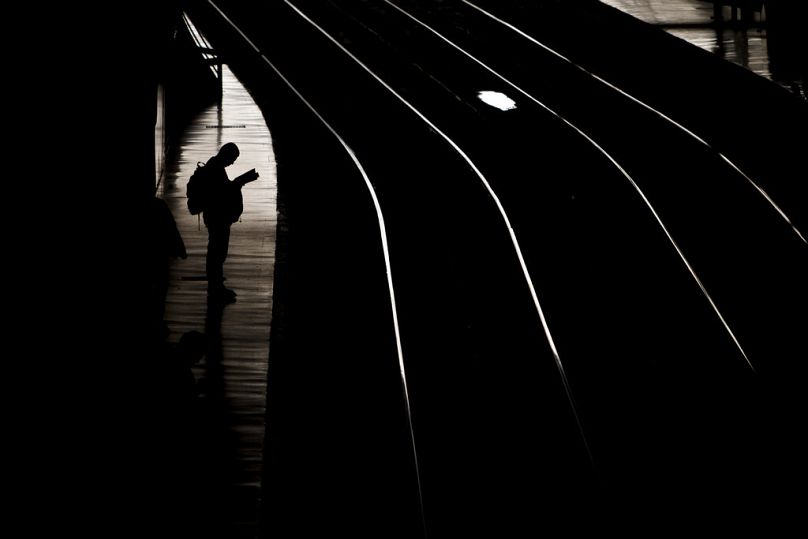 A man waits for the train in Atocha train station in Madrid, March 2014