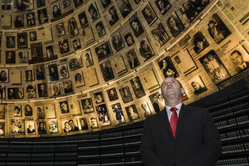 Bulgarian President Rumen Radev looks at pictures of Jews killed during the Holocaust, in the Hall of Names at Yad Vashem Holocaust Museum in Jerusalem, March 2018
