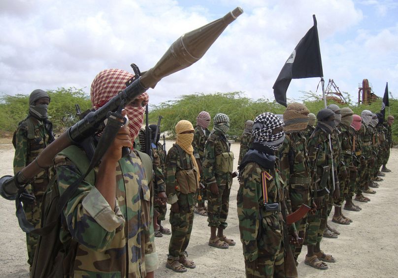 Al-Shabaab fighters display weapons as they conduct military exercises in northern Mogadishu, October 2010