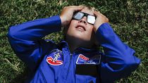 Tyler Hanson, of Fort Rucker, Ala., watches the sun moments before the total eclipse, Monday, Aug. 21, 2017, in Nashville, Tenn. 