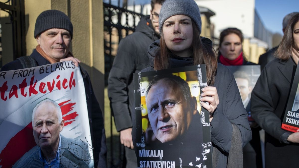 Protesters hold posters with portraits of detained opposition activists during a protest demanding freedom for political prisoners in Belarus, in front of the Belarus Embassy,