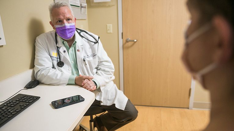 Dr Lance Owens demonstrates the use of an AI tool on a smartphone. Dr Lance Owens demonstrates the use of an AI tool on a smartphone.