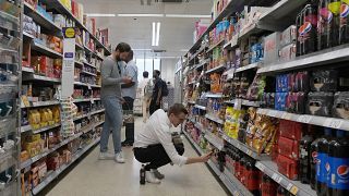 Shoppers buy food in a supermarket in London, Wednesday, Aug. 17, 2022. 