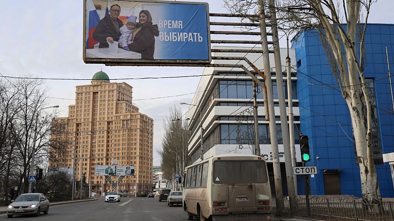 A billboard which promotes the upcoming presidential election with words in Russian: "Time to vote" is seen in a street in Donetsk of Russian-controlled Donetsk region.