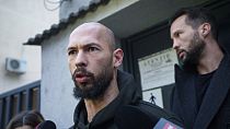 Andrew Tate talks to media upon exiting a police detention facility in Bucharest, Romania, Tuesday, March 12, 2024. 