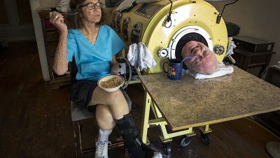 In this Friday, April 27, 2018 photo, attorney Paul Alexander looks out from inside his iron lung at his home in Dallas.