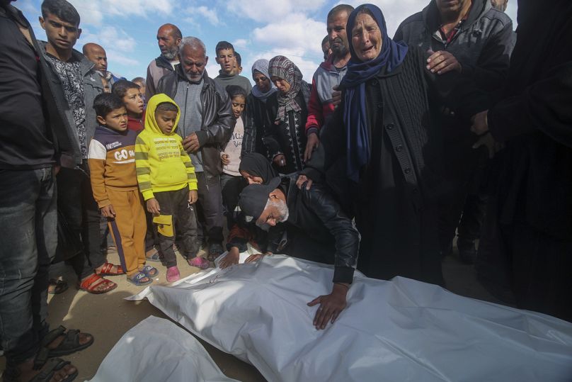 Palestinos lloran sobre los cuerpos de sus familiares muertos en el bombardeo israelí de la Franja de Gaza, en Khan Younis, viernes 22 de marzo de 2024.