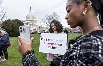 TikTok users monitor voting at the Capitol in Washington, as the House passed a bill that would lead to a nationwide ban of the popular video app.