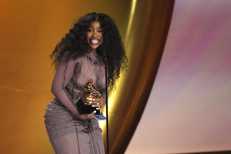 SZA accepts the award for best R&B song for "Snooze" during the 66th annual Grammy Awards in February