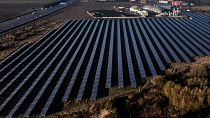 A solar farm, front, and a biogas plant, rear, are seen in Oberkraemer, Germany, Thursday, Oct. 28, 2021.