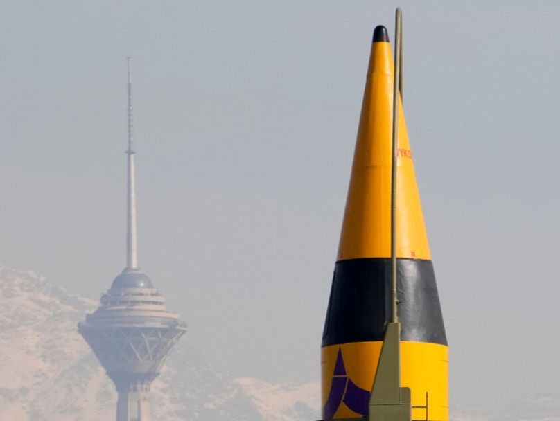 An Iranian-built missile is displayed during a rally in Tehran with the Milad telecommunication tower in the background.
