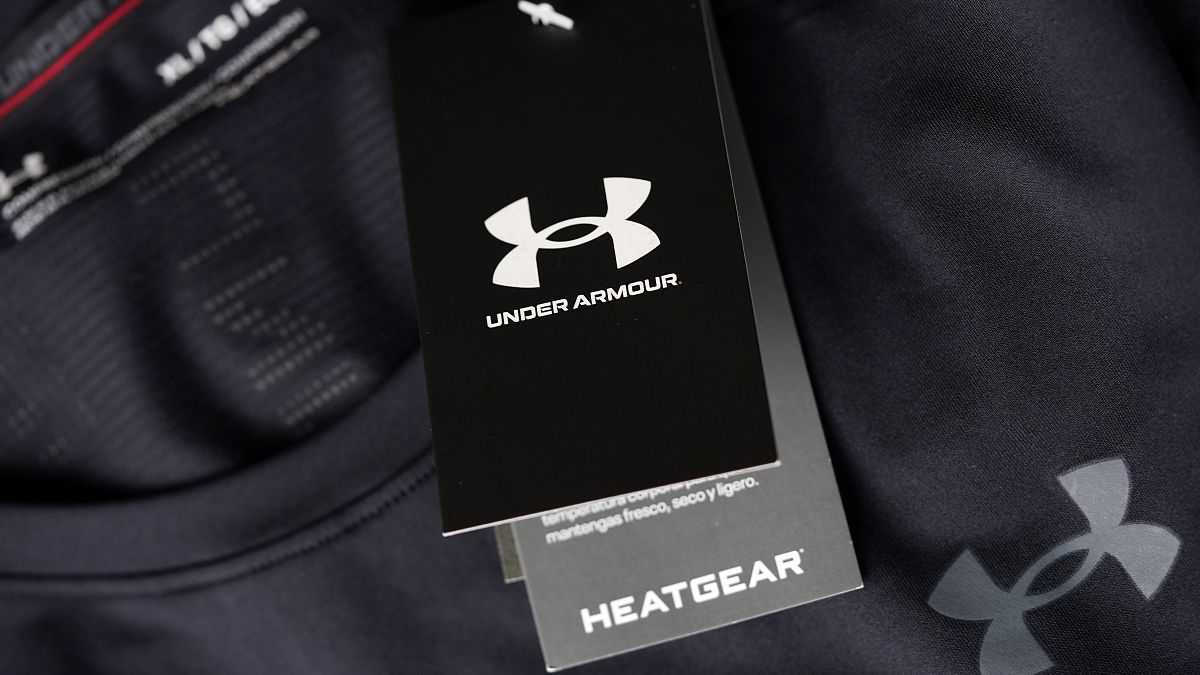 The company logo graces a sales tag on a compression shirt for sale in an Under Armour store.