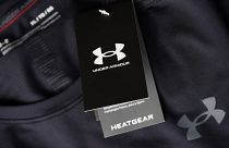 The company logo graces a sales tag on a compression shirt for sale in an Under Armour store.