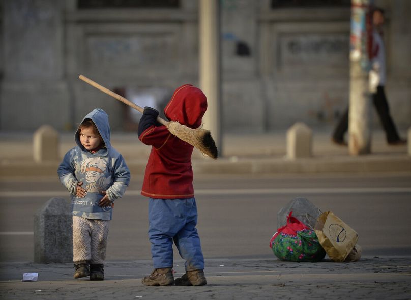 A child holds a broom in Bucharest, February 2014