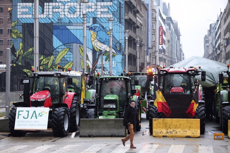 Tractors are parked behind a blockade in the European Quarter during a protest of farmers outside a meeting of EU agriculture ministers in Brussels, Feb. 26, 2024