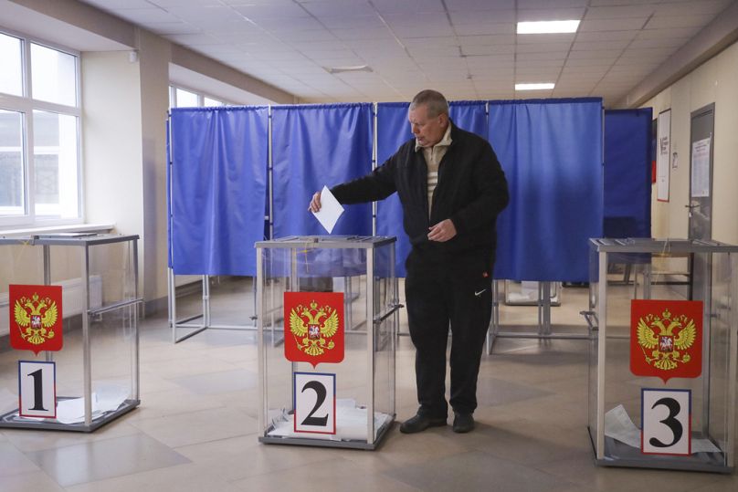 A man casts a ballot at a polling station during a presidential election in Mariupol, Russian-occupied Donetsk region, eastern Ukraine