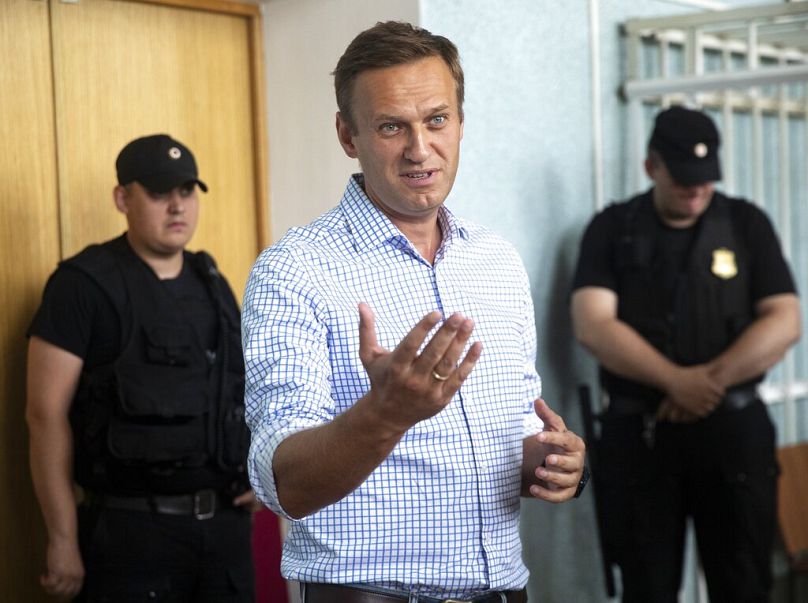 Russian opposition activist Alexei Navalny, left, gestures in a court before a hearing in Moscow, Russia, Monday, July 1, 2019.