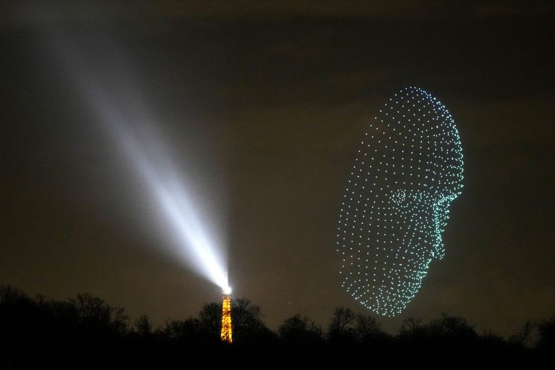 A luminous drone hovers near the Eiffel Tower in Paris, December 2023
