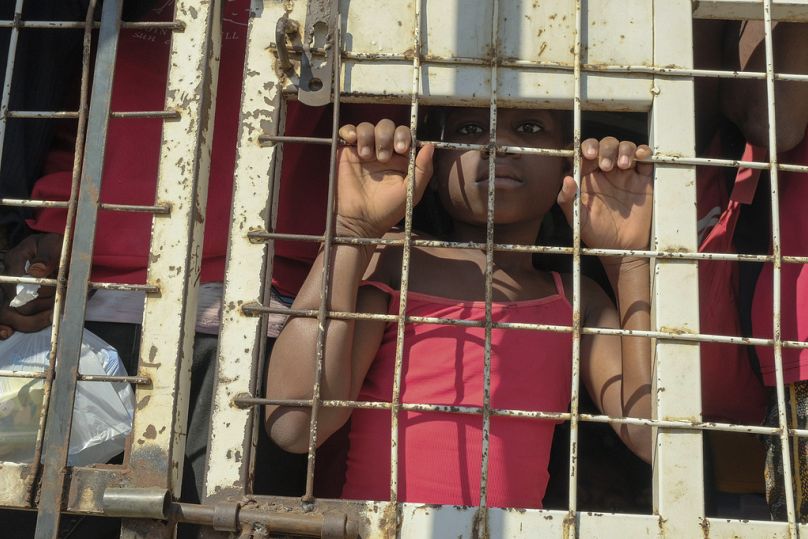 A child stands amid people who were detained for deportation to Haiti inside a police truck on a border bridge that connects Dajabon, Dominican Republic with Haiti, 18/03/24.