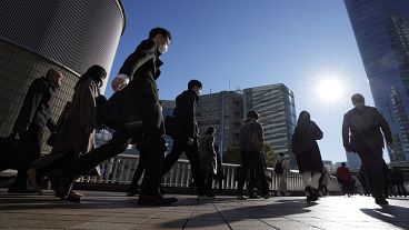 Commuters walk in a passageway during a rush hour at Shinagawa Station Wednesday, Feb. 14, 2024, in Tokyo. 