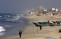 Palestinian fishermen walk on the beach in Gaza City, Wednesday, Nov. 26, 2008. 