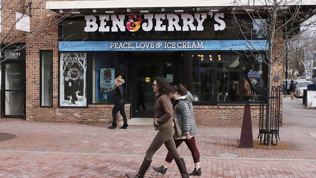 Pedestrians walk on Church St., past the Ben & Jerry's shop, in Burlington, Vt., Wednesday, March 11, 2020