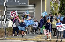 People protest outside an Auckland school near where a vape shop was set to open, Aug 1, 2023.